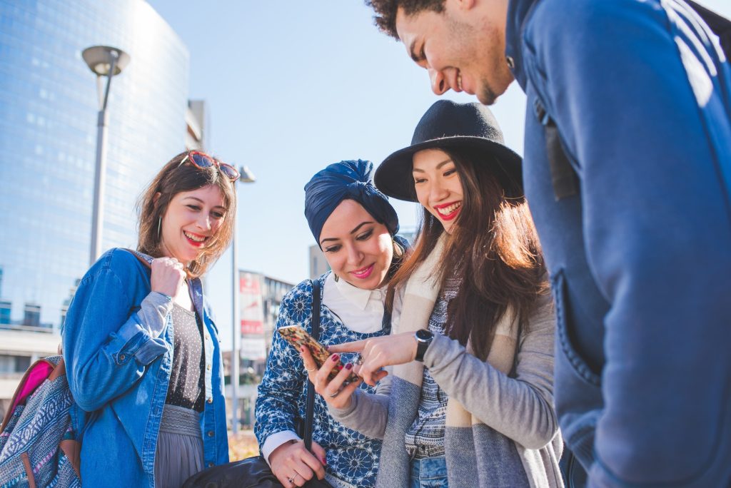 Multiracial group young people using smartphone